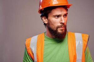 Mens in werken uniform oranje verf veiligheid werk bijgesneden visie foto