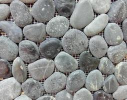 grijze zee kiezelsteen stenen muur textuur achtergrond foto