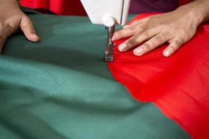 bangladesh, december 09, 2017, md uitslag alam, een jong kleermaker besteedt een bezig tijd maken bangladesh nationaal vlaggen verder van zege maand in de buurt guistan, dhaka. foto