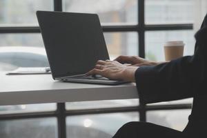 zakelijke professionals. groep jonge zelfverzekerde zakenmensen die gegevens analyseren met behulp van de computer terwijl ze tijd op kantoor doorbrengen foto