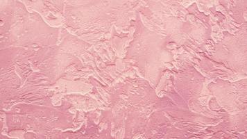 koraal roze grunge abstract kunst achtergrond van getextureerde gepleisterd geschilderd steen muur foto