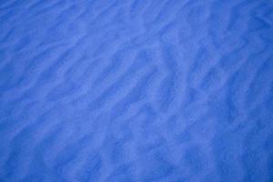 blauw achtergrond met zand in de vorm van zand golven foto