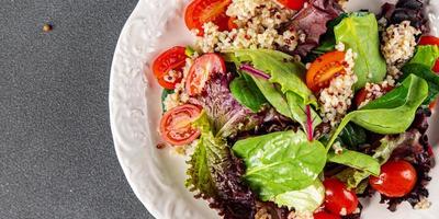 salade quinoa, tomaat, groen sla mengen gezond maaltijd voedsel tussendoortje Aan de tafel kopiëren ruimte voedsel achtergrond rustiek top visie foto