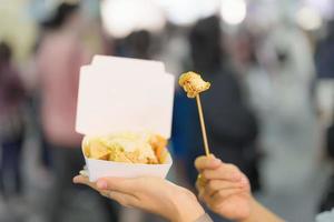 vrouw hand- Holding stinkend tofu Bij nacht markt, beroemd Taiwanees straat voedsel van Taiwan. exotisch voedsel in lokaal markt foto