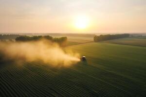 antenne visie van trekker sproeien pesticiden Aan groen soja plantage Bij zonsondergang. ai gegenereerd foto