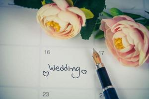 herinnering bruiloft dag in kalender planning en fontein pen met kleur toon. foto