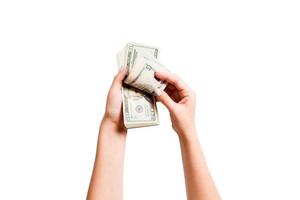 top visie van vrouw handen tellen dollar bankbiljetten Aan wit geïsoleerd achtergrond. investering en welvaart concept foto