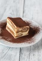 portie tiramisu op het witte bord foto