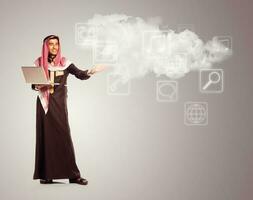 jong glimlachen Arabisch met laptop shows virtueel pictogrammen van de wolk onderhoud foto