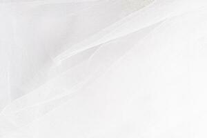 delicaat structuur van de achtergrond. elegant zacht tule kleding stof. bruids bruiloft folie detailopname voor ontwerp, tekst. foto