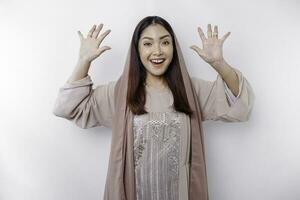 portret van een jong mooi Aziatisch moslim vrouw vervelend een hoofddoek gebaren eid mubarak groet foto