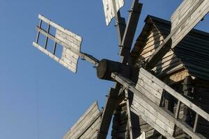 oud oekraïens houten windmolen tegen blauw lucht foto