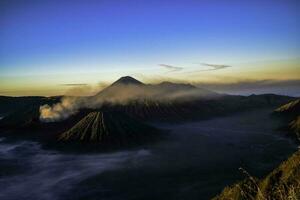 mooi kleurrijk zonsopkomst over- monteren bromo en wild eiland in monteren bromo nationaal park foto