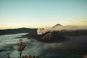 mooi kleurrijk zonsopkomst over- monteren bromo en wild eiland in monteren bromo nationaal park foto