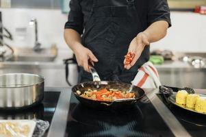 mannelijke chef-kok chili schotel toe te voegen. mooi fotoconcept van hoge kwaliteit en resolutie