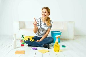 schoonmaak dame zittend Aan de verdieping schoonmaak benodigdheden schoonmaak huis interieur foto