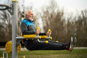 een senior Mens aan het doen fysiek opdrachten foto