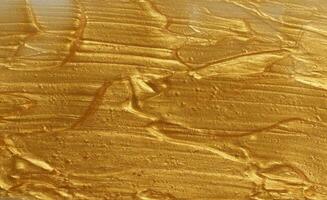 monster van gouden schitteren gel met klein deeltjes, structuur van markeerstift cosmetica, lippenstift, blozen foto