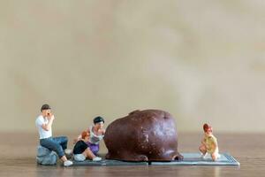 miniatuur mensen gelukkig familie genieten van chocola foto