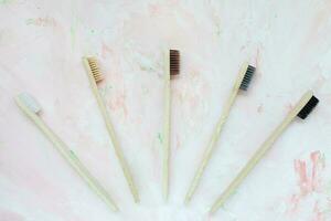 vijf natuurlijk houten bamboe tandenborstels Aan roze foto