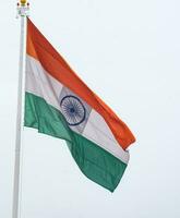 indiase vlag hoog op connaught plaats met trots in blauwe lucht, indiase vlag wapperen, indiase vlag op onafhankelijkheidsdag en republiek dag van india, tilt-up shot, wuivende indische vlag, har ghar tiranga foto