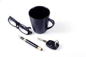 koffiekopje met bril, autosleutel en pen voor minimalistisch stijlconcept met ruimte voor uw tekst foto