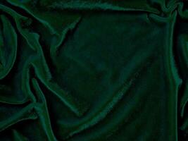 groen fluweel kleding stof structuur gebruikt net zo achtergrond. leeg groen kleding stof achtergrond van zacht en glad textiel materiaal. Daar is ruimte voor tekst. foto