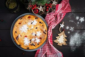 Kerstmis fruit taart, pudding Aan donker tafel. top visie, bovengronds, kopiëren ruimte. foto
