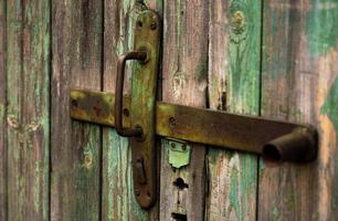 oude houten deur met handvat een oude houten deur met gebarsten verf