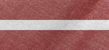 Letland kleding stof vlag katoen materiaal breed vlaggen behang gekleurde kleding stof Letland vlag achtergrond foto
