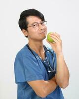jong Aziatisch mannetje vrouw dokter vervelend schort uniform tuniek schort houden foto
