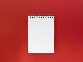 blanco vel notebook rode achtergrond onderwijsconcept plat leggen met kopie ruimte stock foto