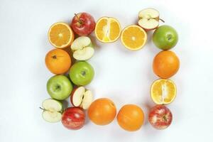 mengen groen rood appel oranje geheel fruit besnoeiing plak voor de helft Aan wit achtergrond foto