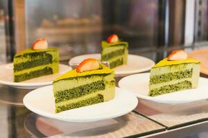 heerlijk plak matcha groen thee taart tonen in taart winkel. foto