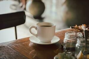 een kop van zwart koffie Aan ontbijt tafel in de ochtend. foto