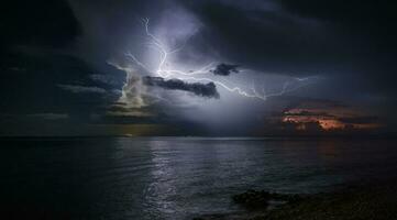 krachtig elektrisch storm over- de zee foto