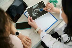dokter gynaecoloog verloskundige cheques de echografie van een zwanger vrouw in een medisch kantoor van een gynaecologisch kliniek foto