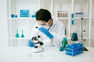 wetenschapper menging chemisch vloeistoffen in de chemie laboratorium. onderzoeker werken in de chemisch een laboratorium foto