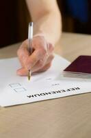 referendum stemming papier, zwart pen, en paspoort Aan de tafel. foto