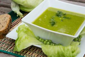 groen erwten room soep met salade bladeren foto