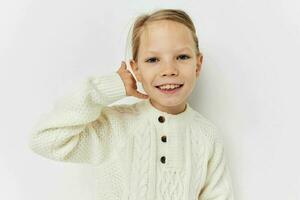 mooi jong meisje in een wit trui elegant kleren kinderjaren ongewijzigd foto