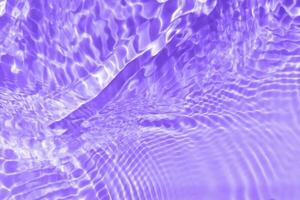 Purper water met rimpelingen Aan de oppervlak. onscherp wazig transparant roze gekleurde Doorzichtig kalmte water oppervlakte structuur met spatten en bubbels. water golven met schijnend patroon structuur achtergrond. foto