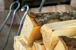 gehakt brandhout gestapeld in houtstapel tegen achtergrond van haard foto