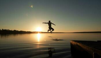 silhouet van jong volwassenen jumping in rustig water Bij zonsondergang gegenereerd door ai foto