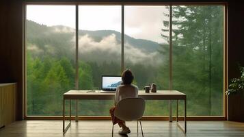 oor visie Dames gebruik makend van laptop in minimalistische kamer met groot glas van venster met natuur visie. generatief ai foto