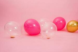 groep van veelkleurig transparant, roze en goud ballonnen aan het liegen Aan de verdieping in de huis voor Valentijnsdag dag, verjaardag, vakantie concept foto