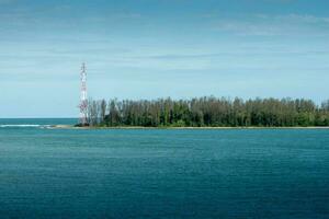 eiland in de midden- van de zee en elektriciteit polen Bij Thailand. foto