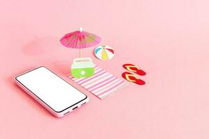 strand paraplu, strand accessoires en slim telefoon Aan roze achtergrond. zomer reizen en vakantie concept. foto