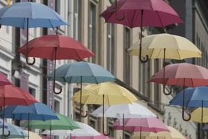 kleurrijke paraplu's hangen op de achtergrond van de oude stad in lviv