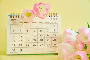 kalender en bloemen dichtbij omhoog foto
